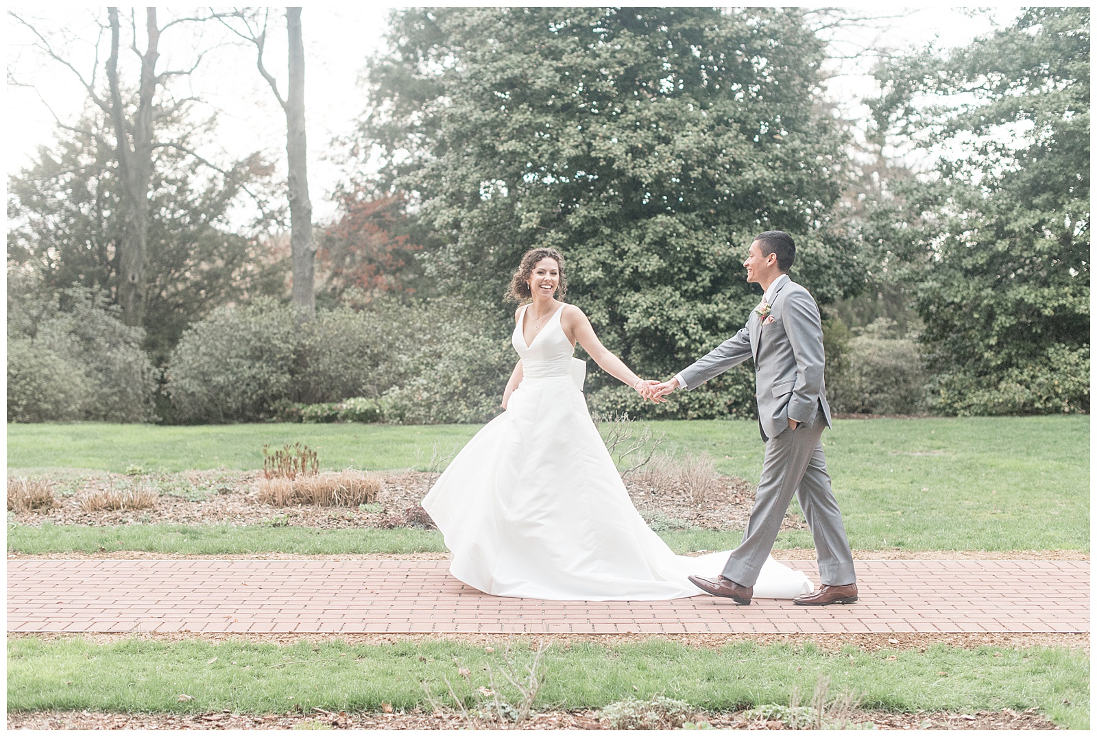 bride and groom walking along brick path at Drumore Estates