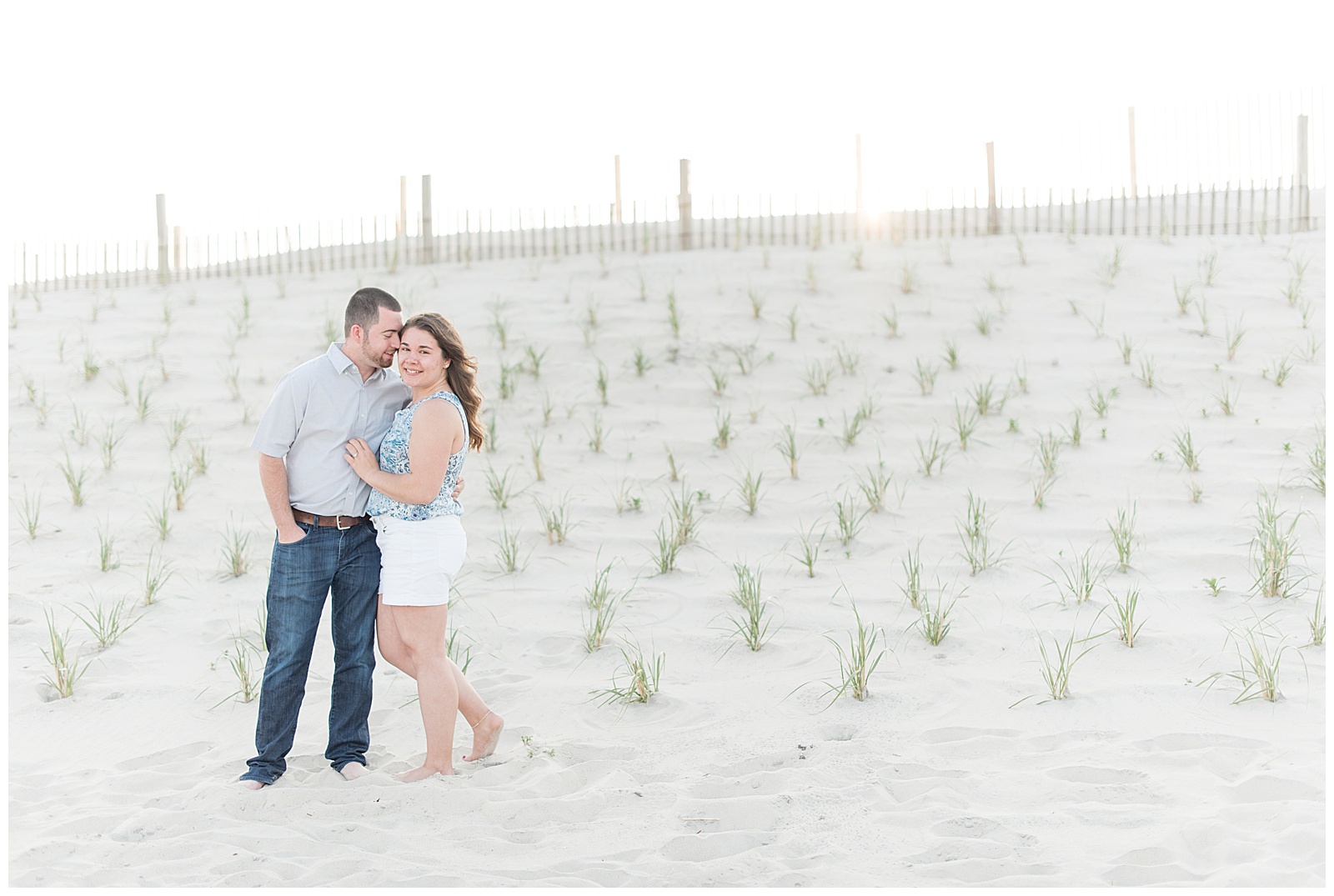 couple smiling in front of dunes at Assateague island