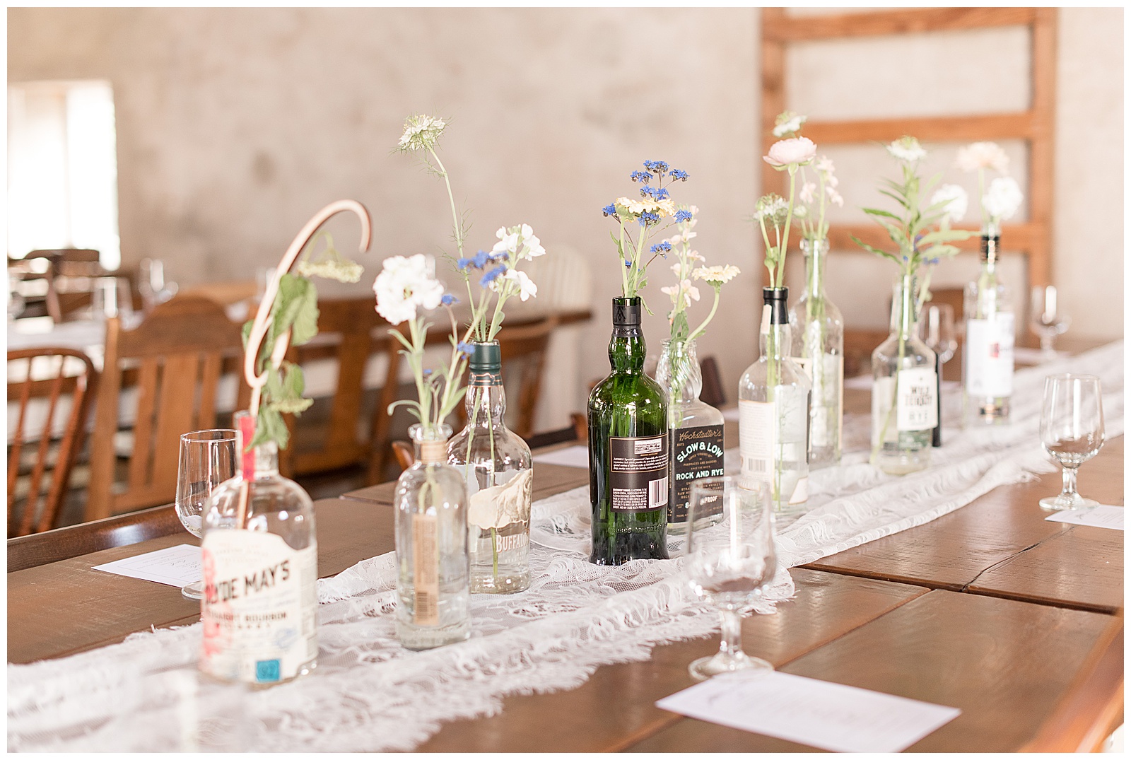 whine bottles and flowers as centerpieces for reception