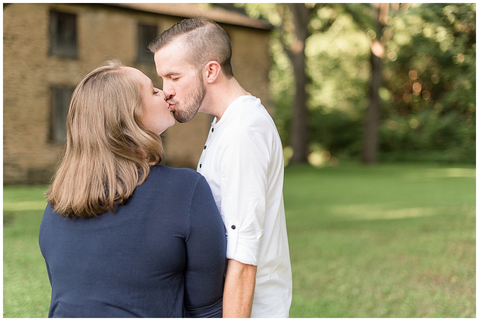 couple kissing in front of James Long House