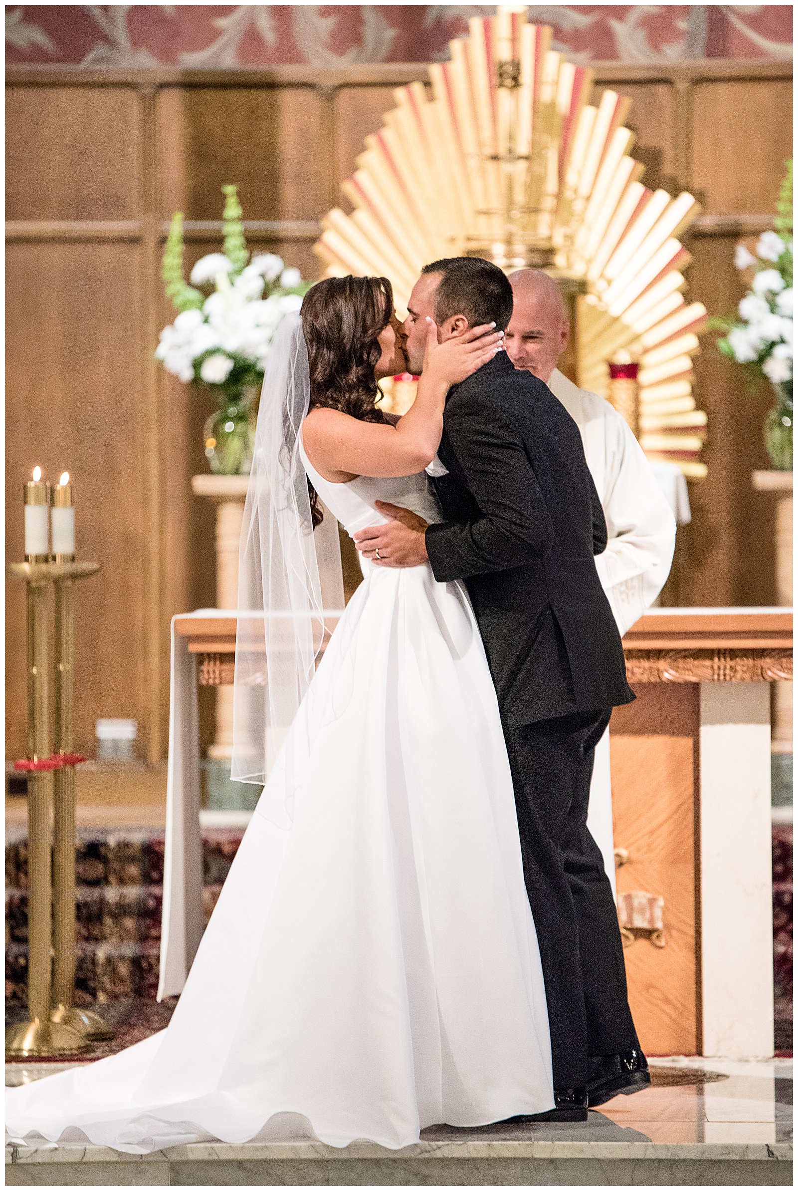 couple kissing at the alter at Sacred Heart Church