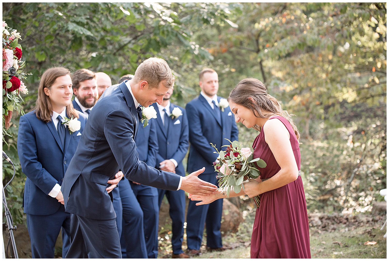 groom and each bridesmaid share unique handshake