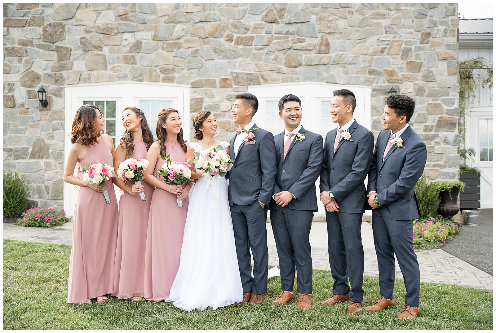 full bridal party shot with pink dresses and blue suits