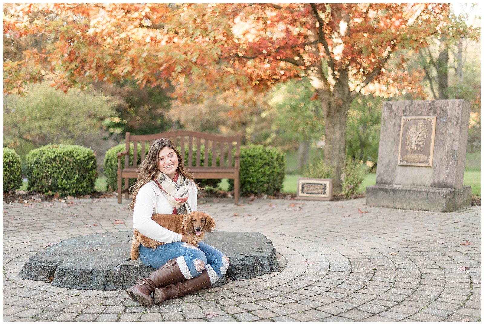 senior girl photos with her puppy with fall leaves behind