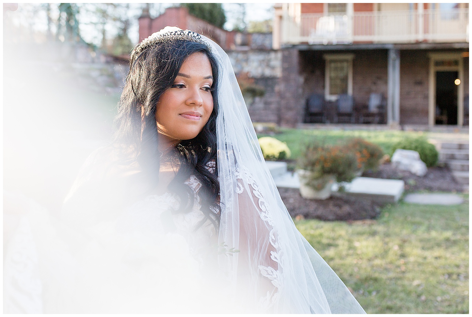 bride smiling off camera with veiling flowing toward camera