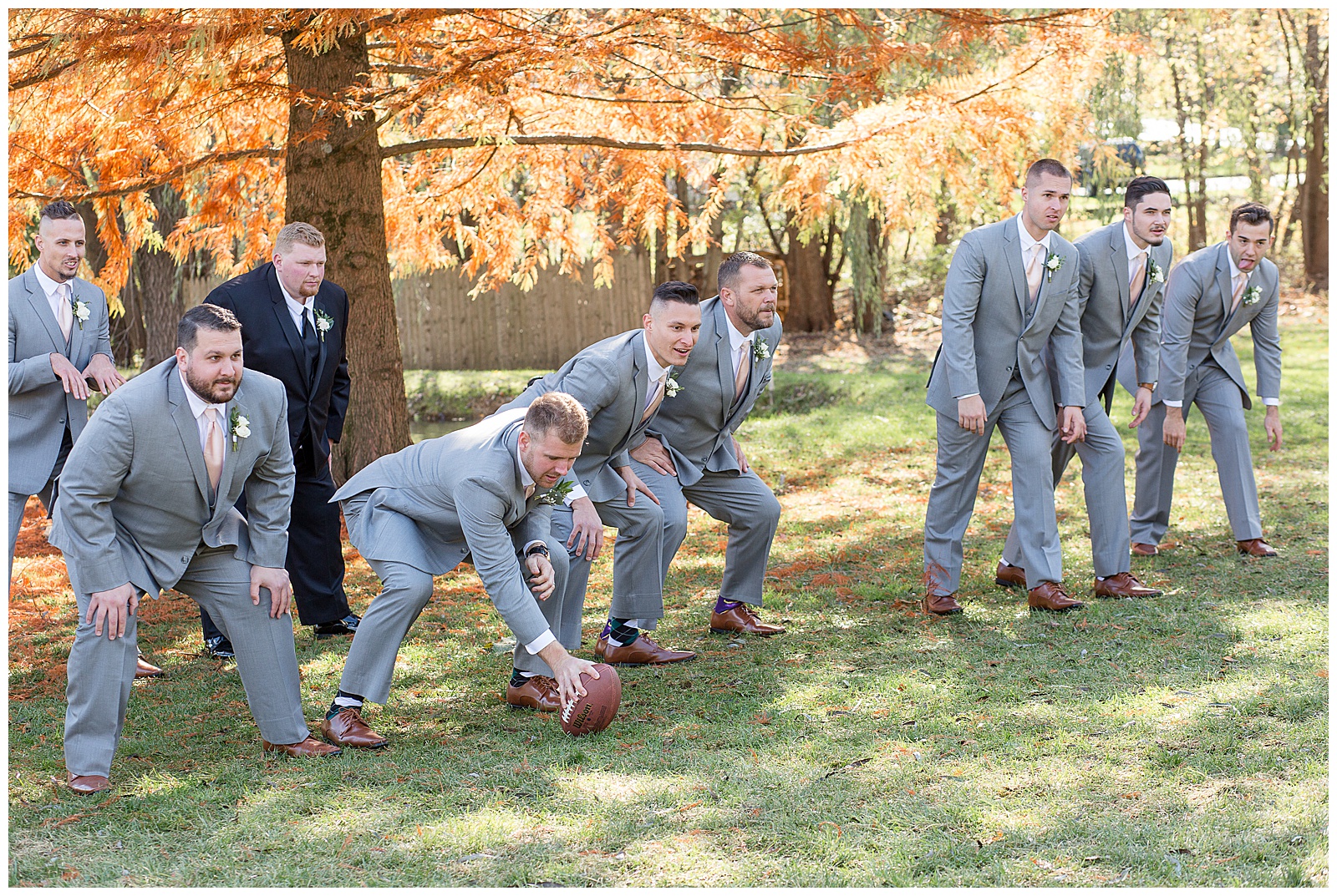 groomsment in football formation with groom as the quarterback