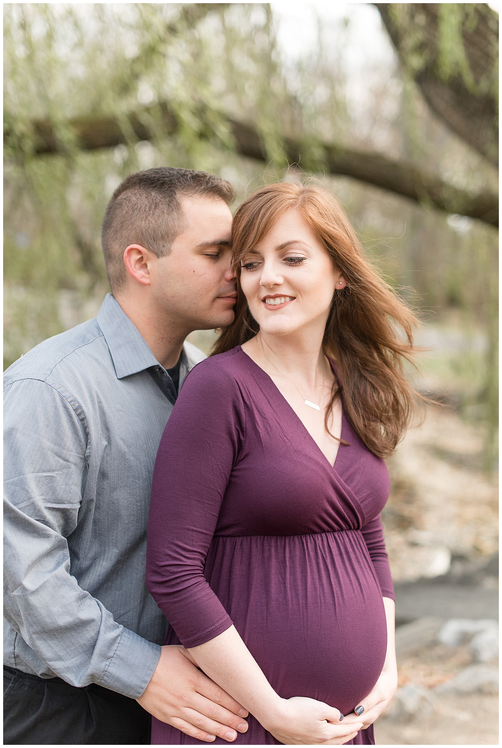 maternity session with guy behind her with arms wrapped around