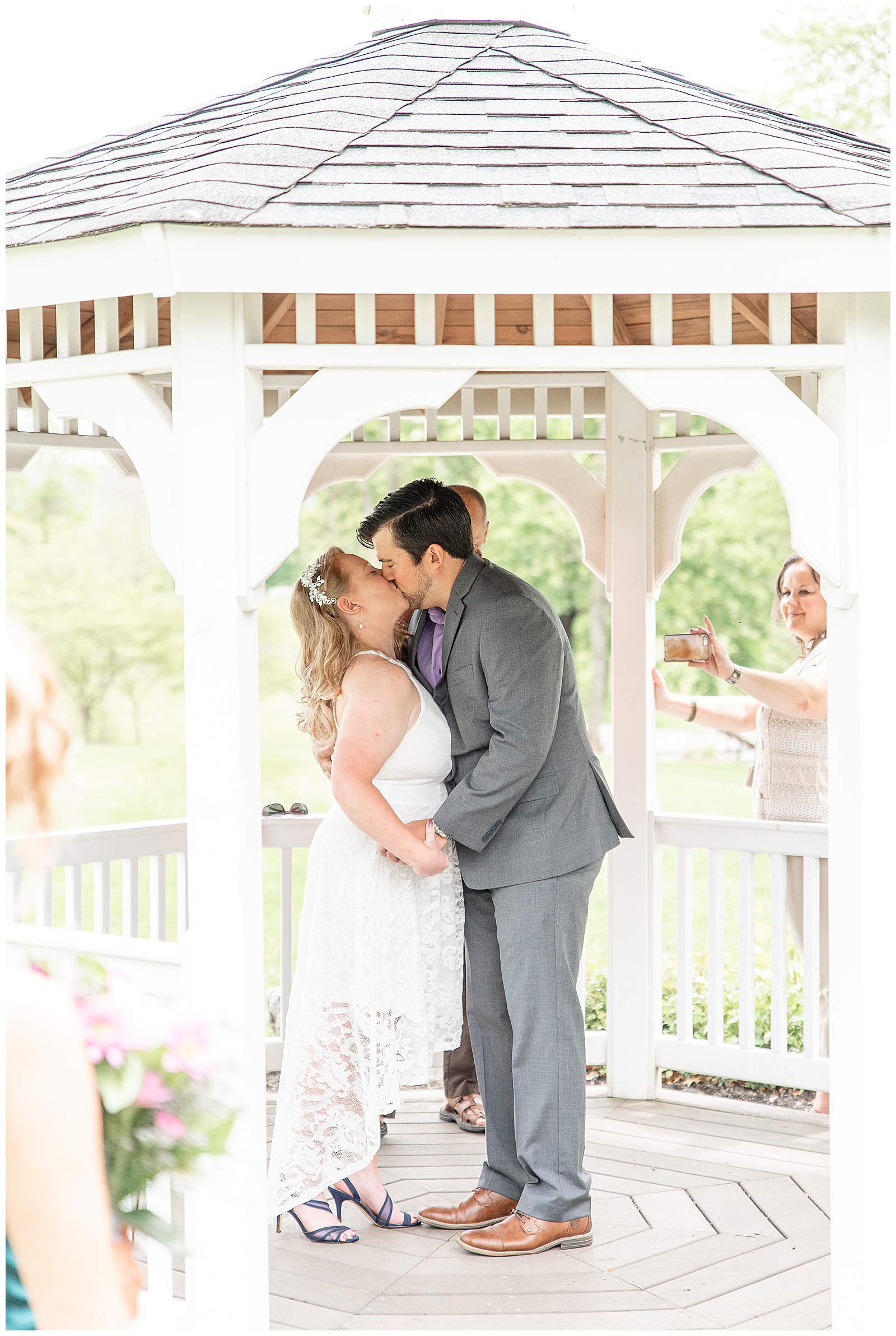 couple kissing in gazebo at intimate ceremony