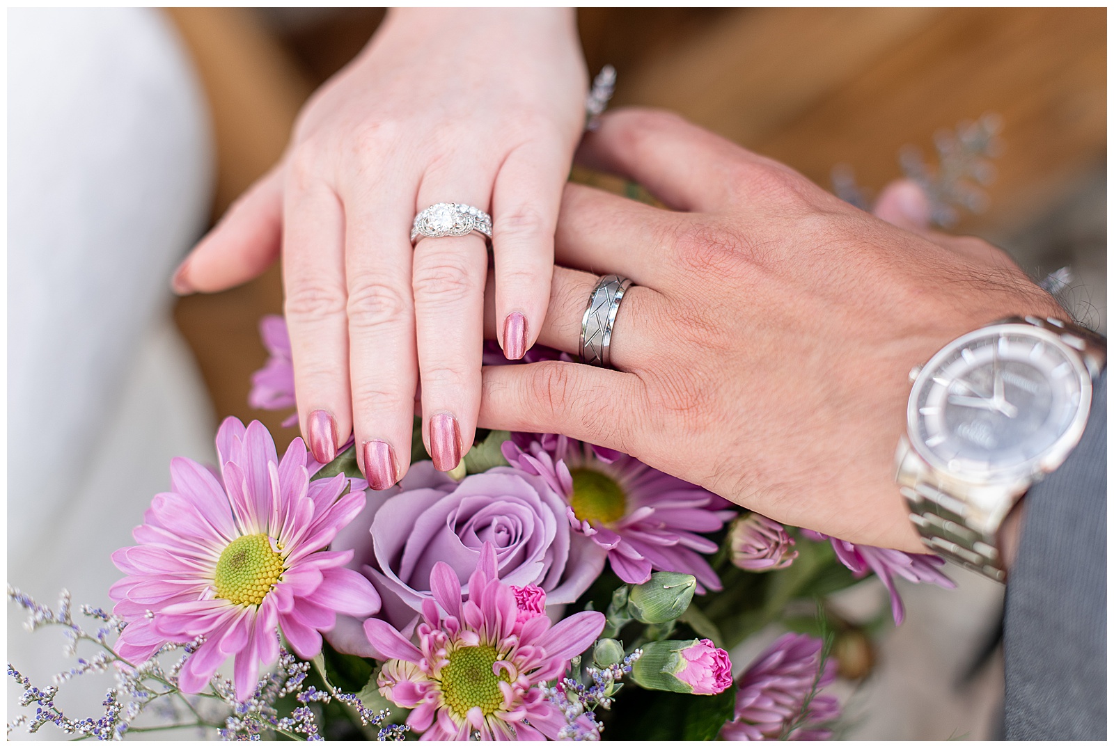 shot of wedding rings on couple's hand