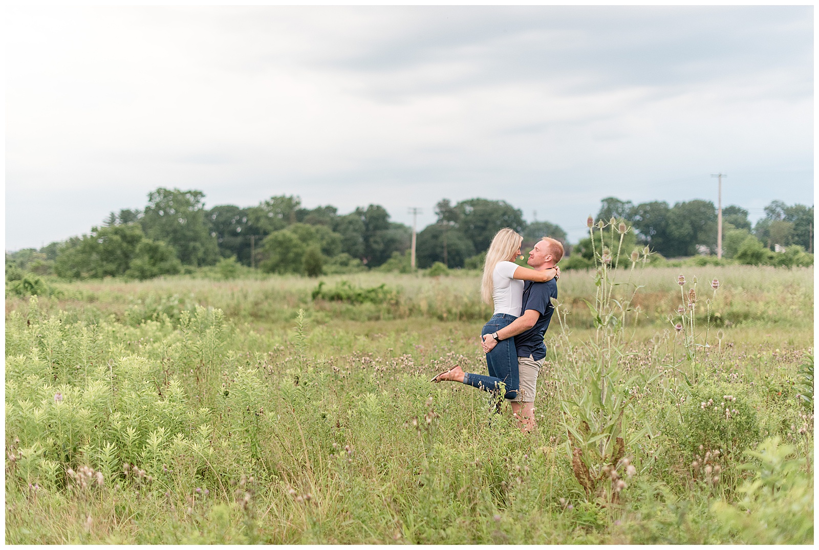 guy lifting girl in middle of tall grass field at Overlook Park, PA