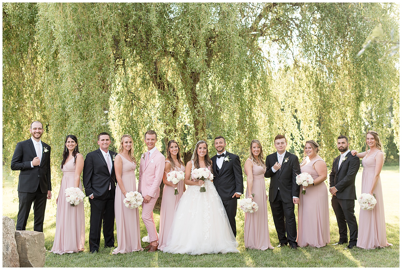 bridal party in front of willow tree at the Barn at Silverstone