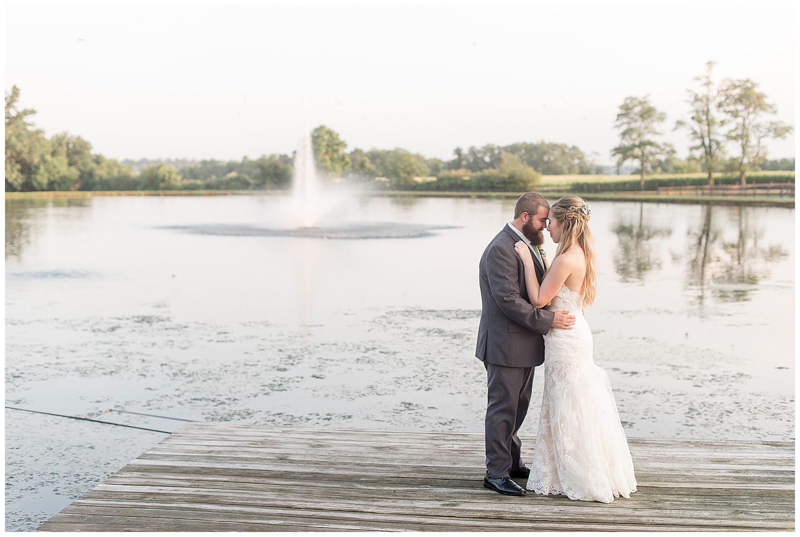 bride and groom standing on dock at Lakeview Farms looking at each other