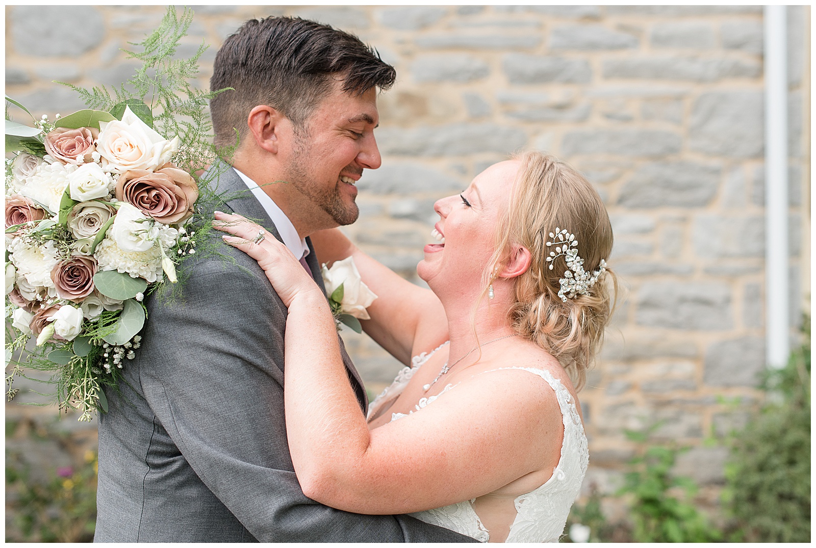 bride and groom portraits of them smiling at each other with bridal bouquet wrapped around grooms back