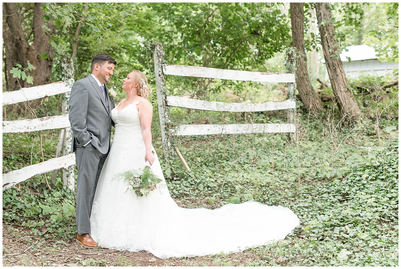 bride and groom portraits in front of white fence