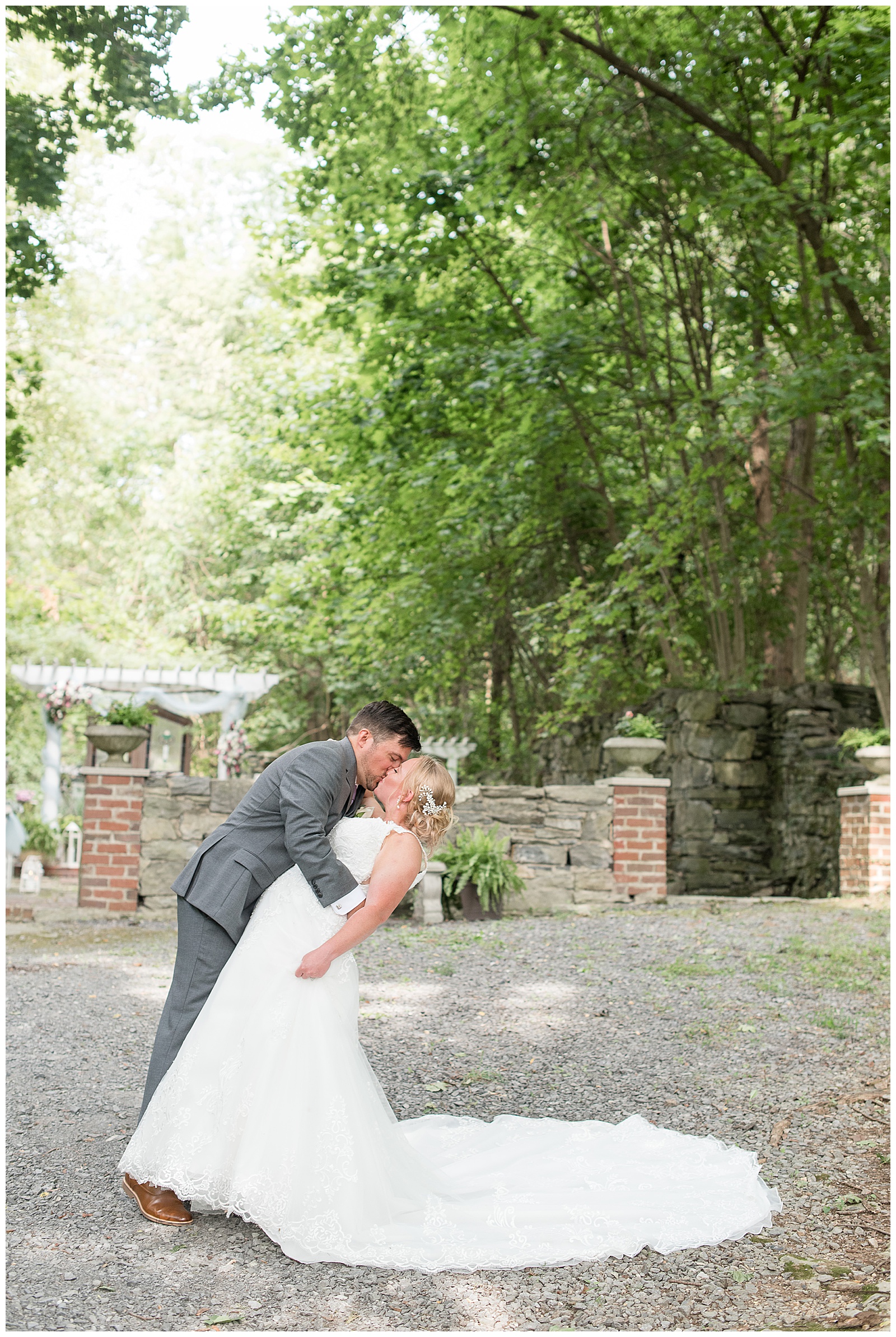 groom tipping bride in front of ceremony location at Fallen Tree Farms