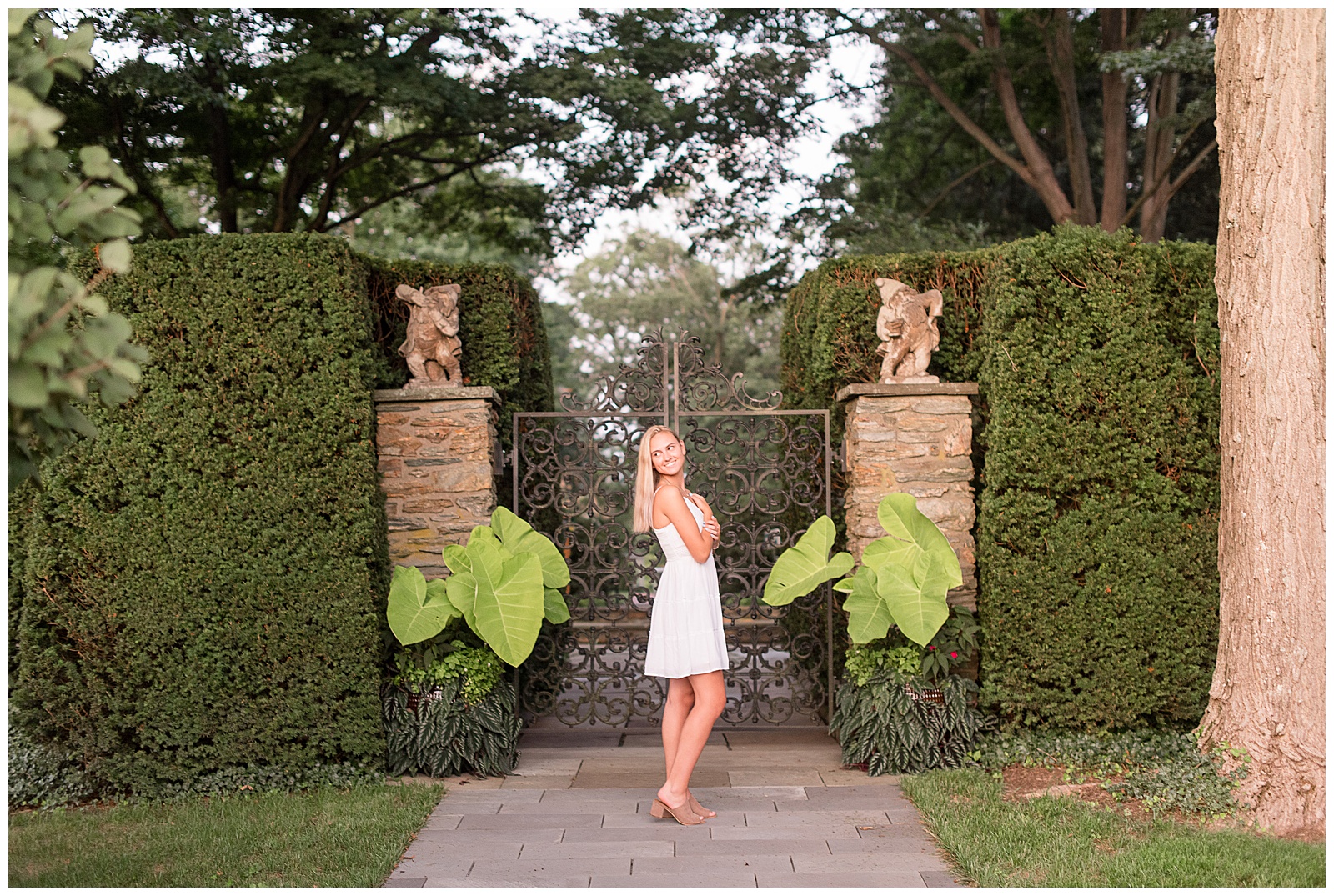 senior session at sunset at Drumore Estate with Iron wrough gate closed behind