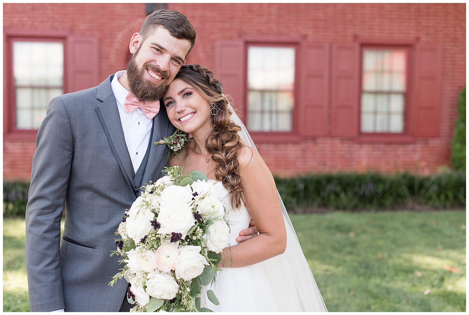 bride and groom portraits with couple smiling at camera and bride holding bouquet of white flowers