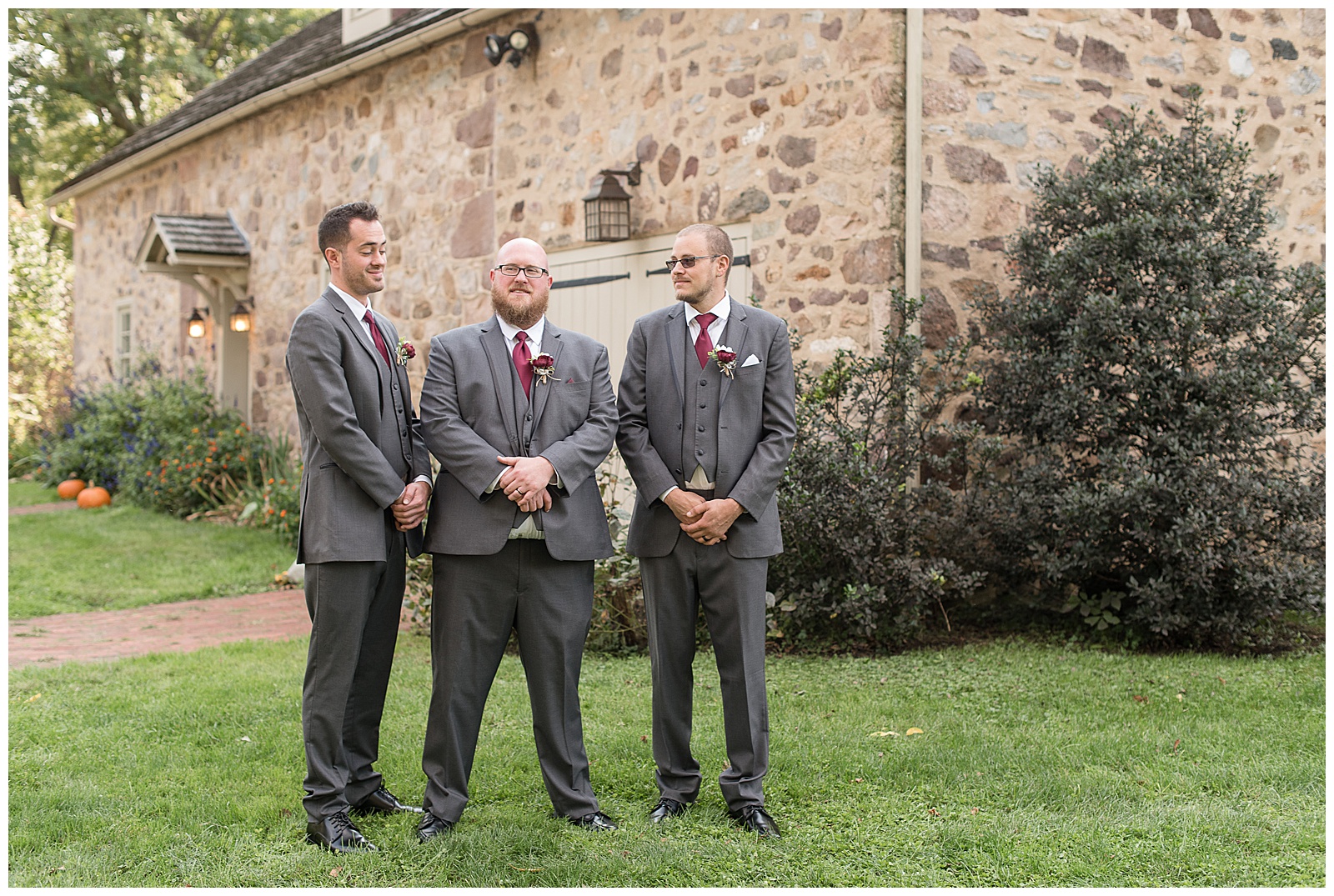groom and groomsmen in gray suits and maroon ties at historic poole forge