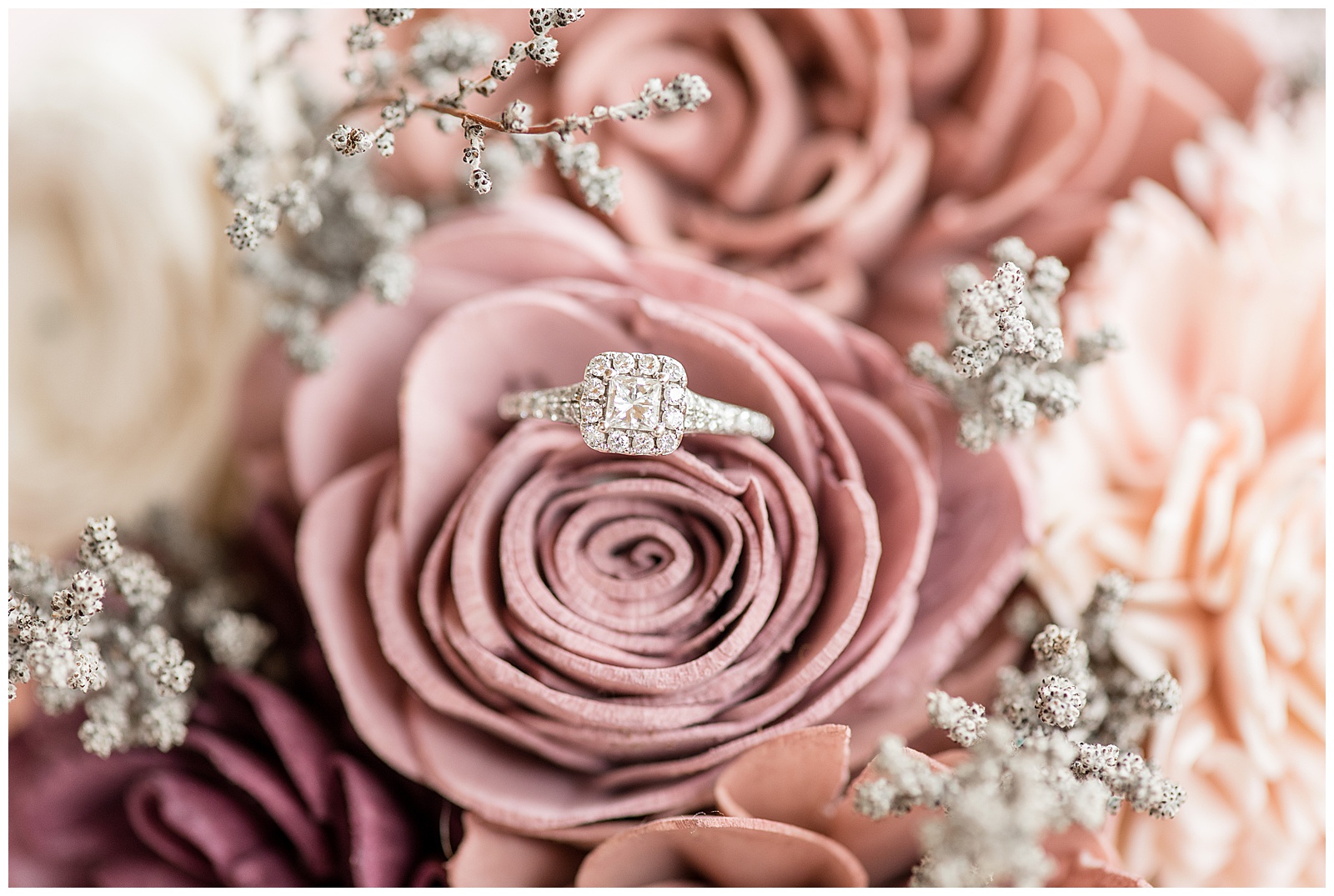 blush roses holding diamond engagement ring at hayfields country club