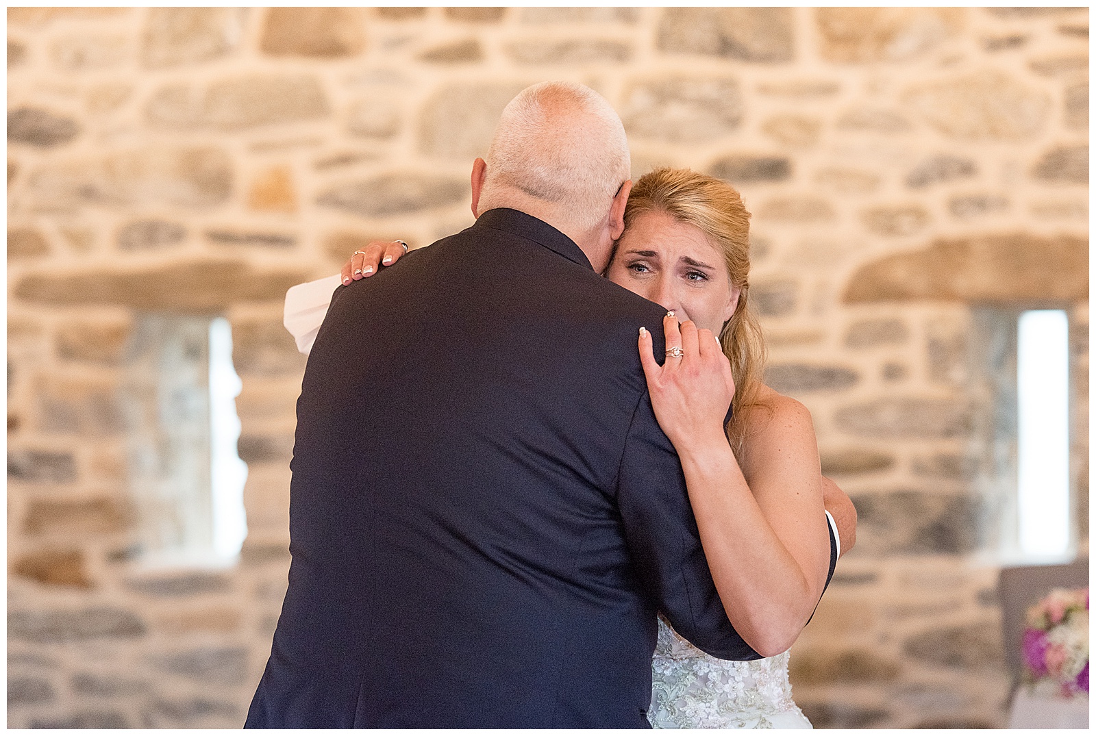 bride hugging her father and crying by stone wall at bluestone estate