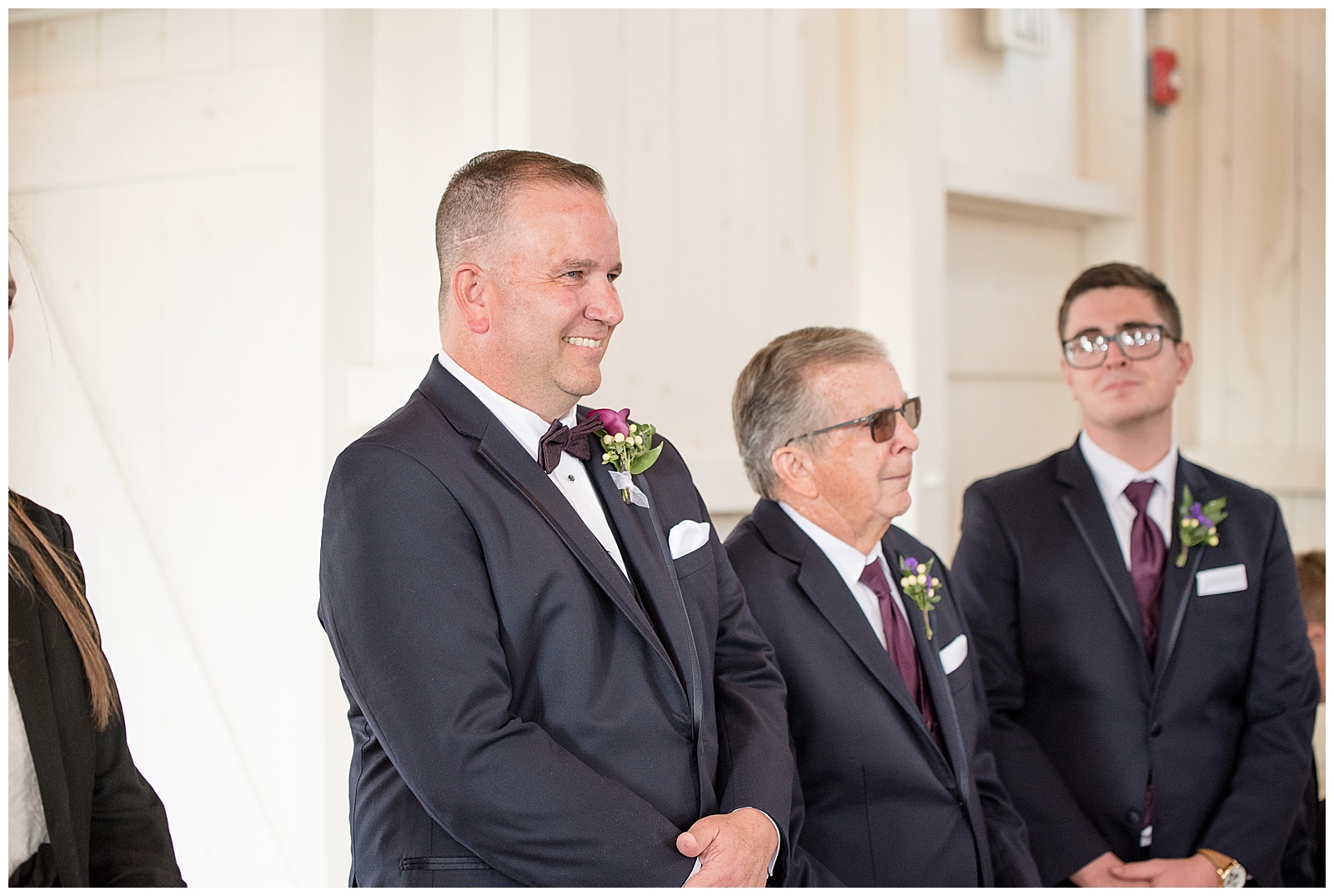 groom smiling as his bride walks down the aisle to him at Stoltzfus Homestead and Gardens