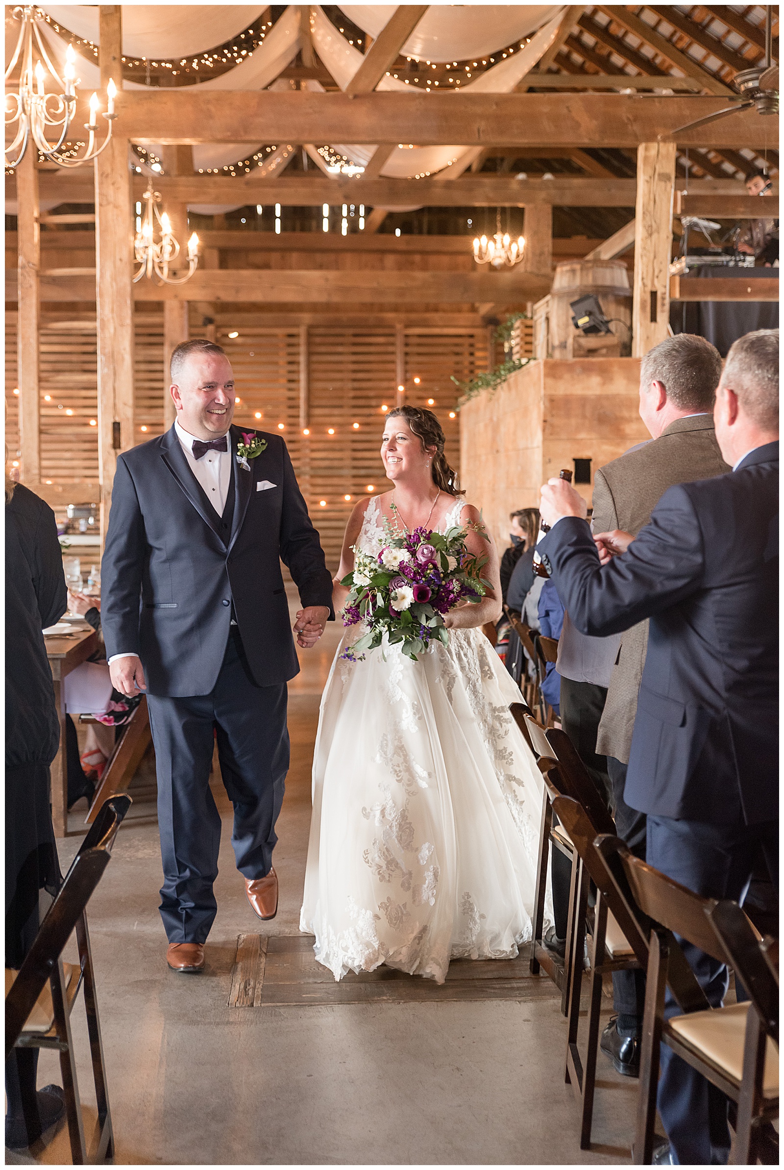 bride and groom walking in to reception space as they are announced at Stoltzfus Homestead and Gardens