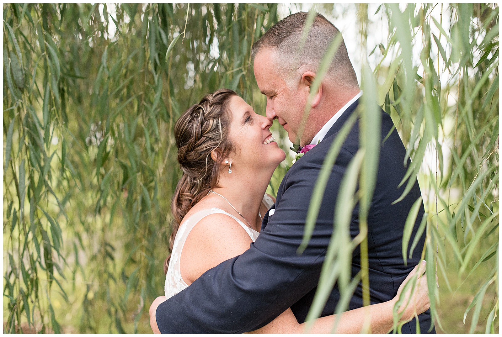 husband and wife portraits among the willow trees at Stoltzfus Homestead and Gardens
