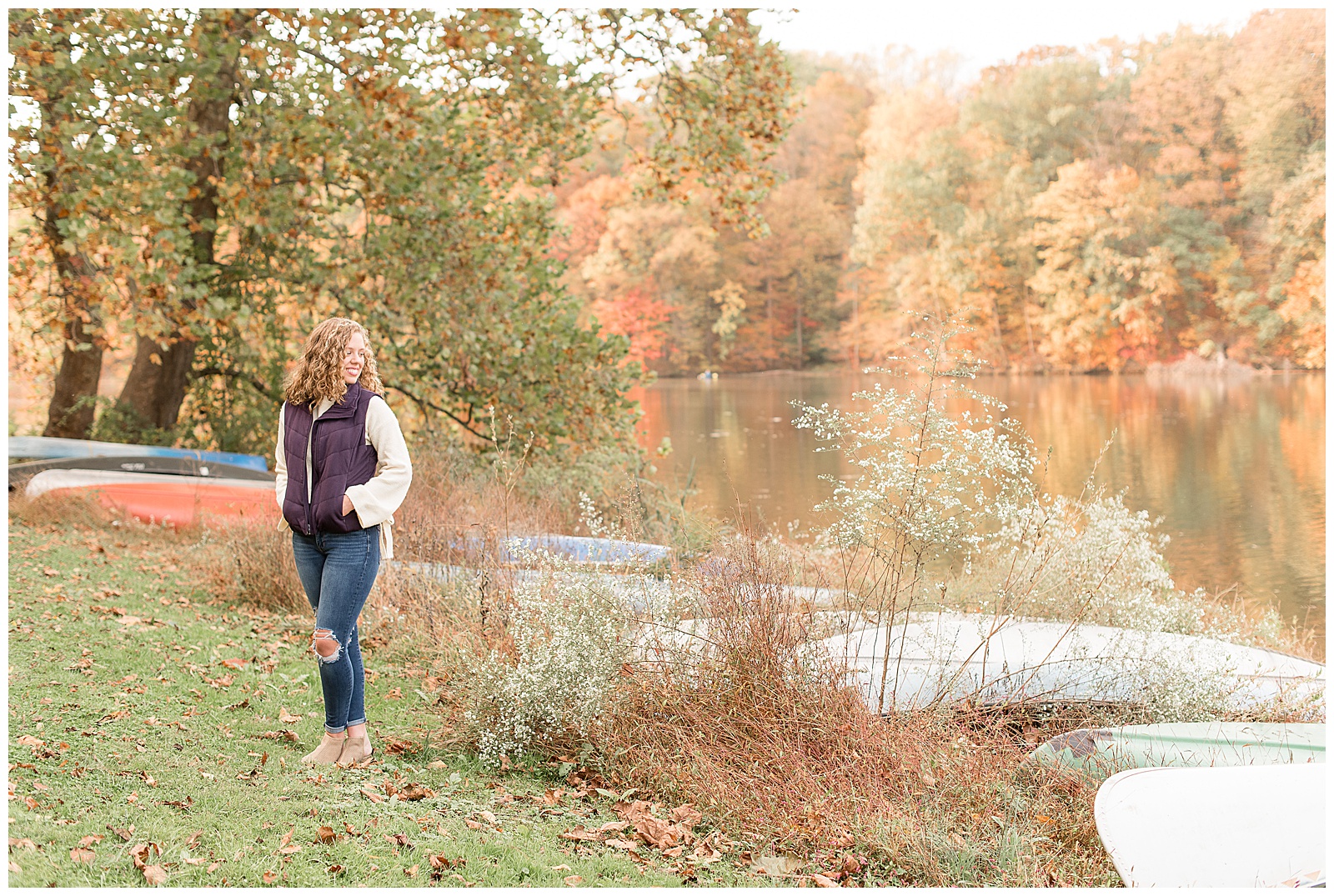 senior girl glancing over shoulder towards speedwell forge lake in lancaster pennsylvania