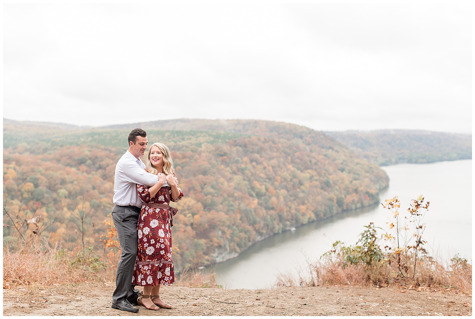 guy wrapping arms around girl on cloudy day by fall foliage at pinnacle point in lancaster pennsylvania
