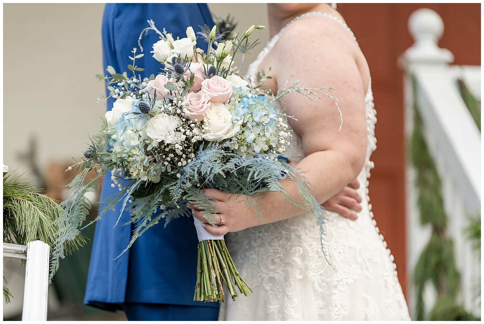 shades of blue and white flower bouquet displayed in front of couple in lancaster pennsylvania