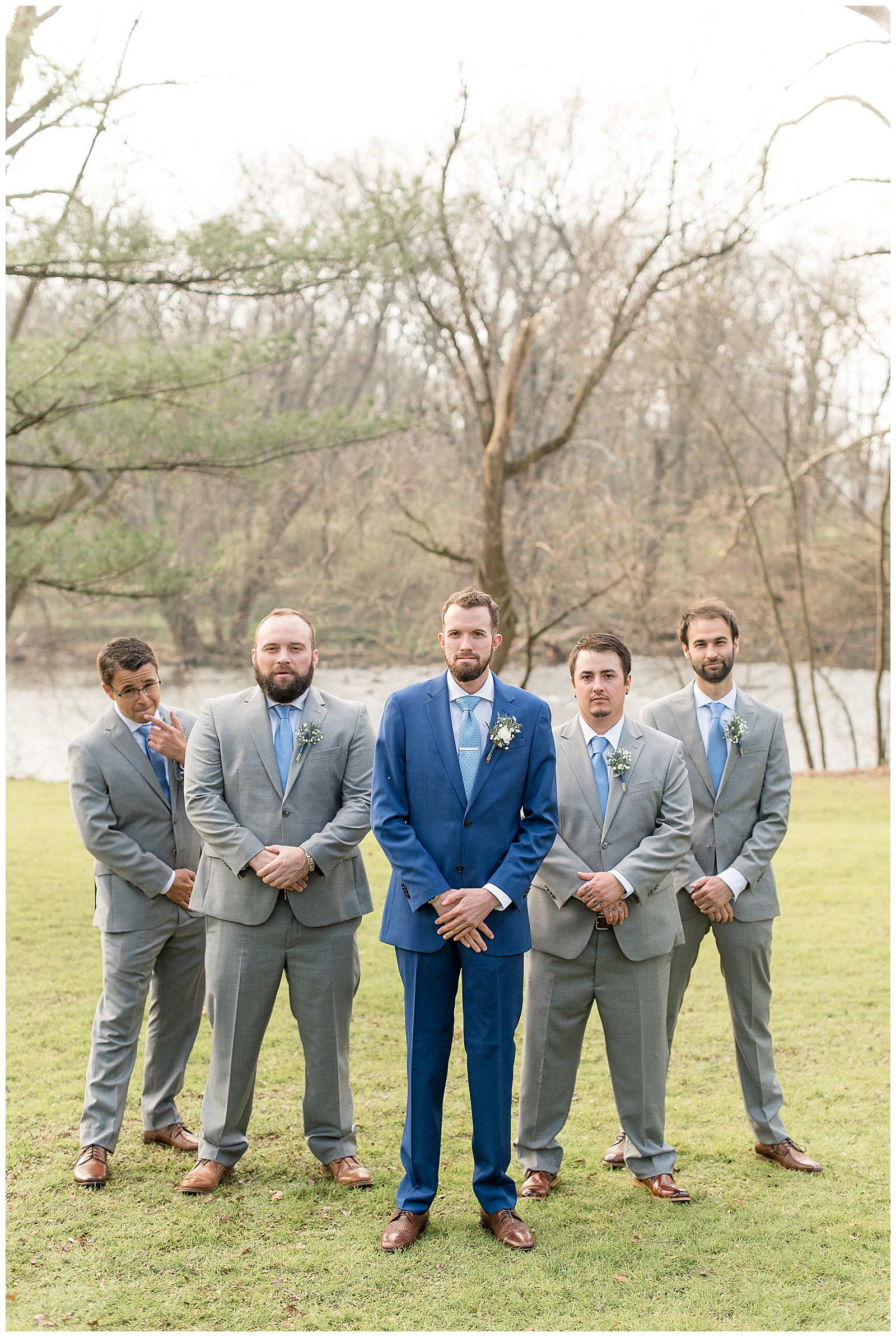 groom with groomsmen in dark gray suits with white shirts and light blue ties at riverdale manor