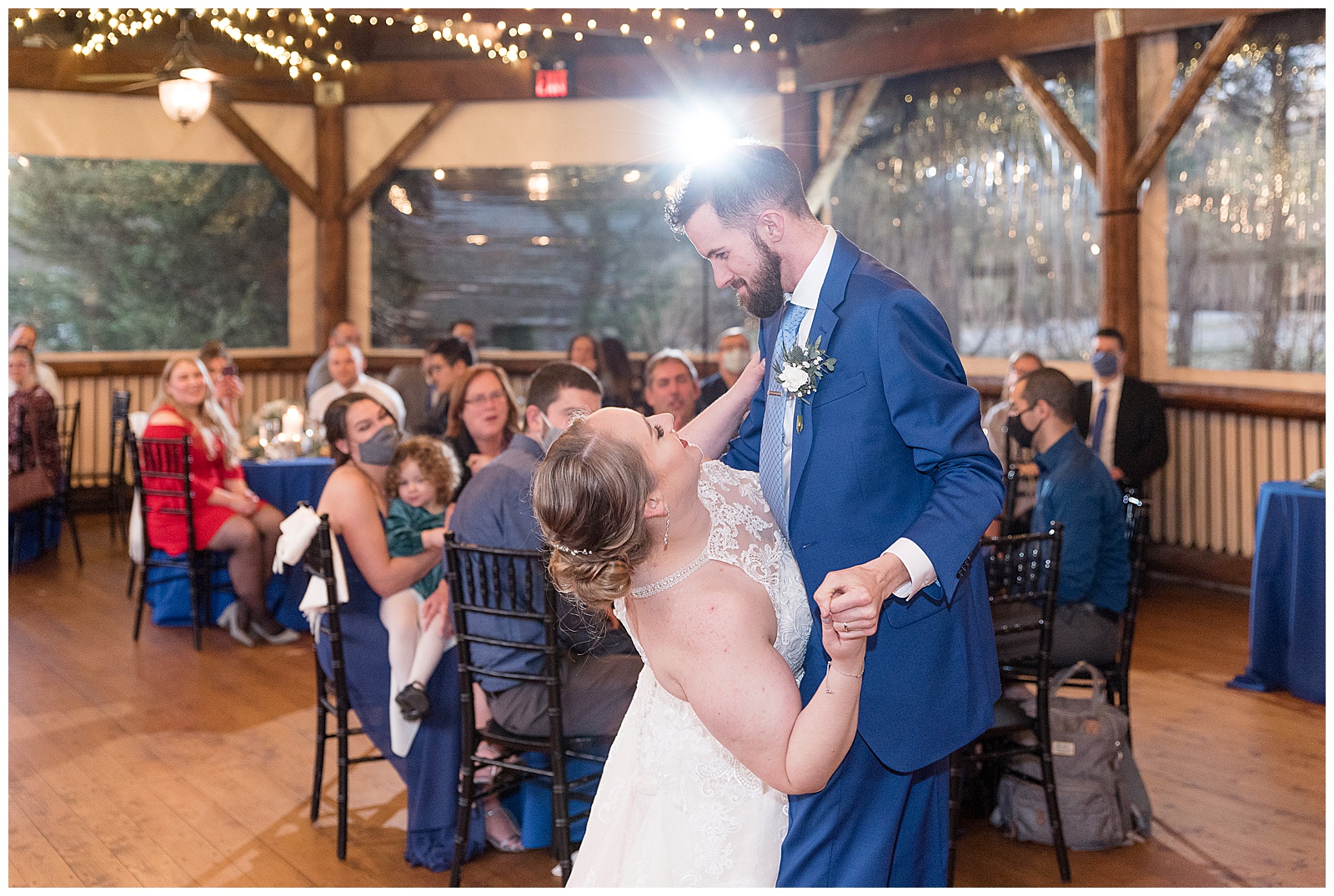 groom dips bride back while dancing at reception in lancaster pa at riverdale manor