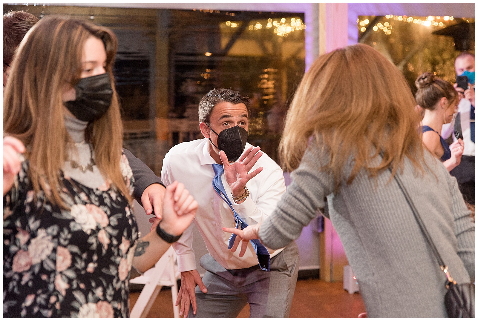 guests dancing together wearing masks during covid wedding at riverdale manor