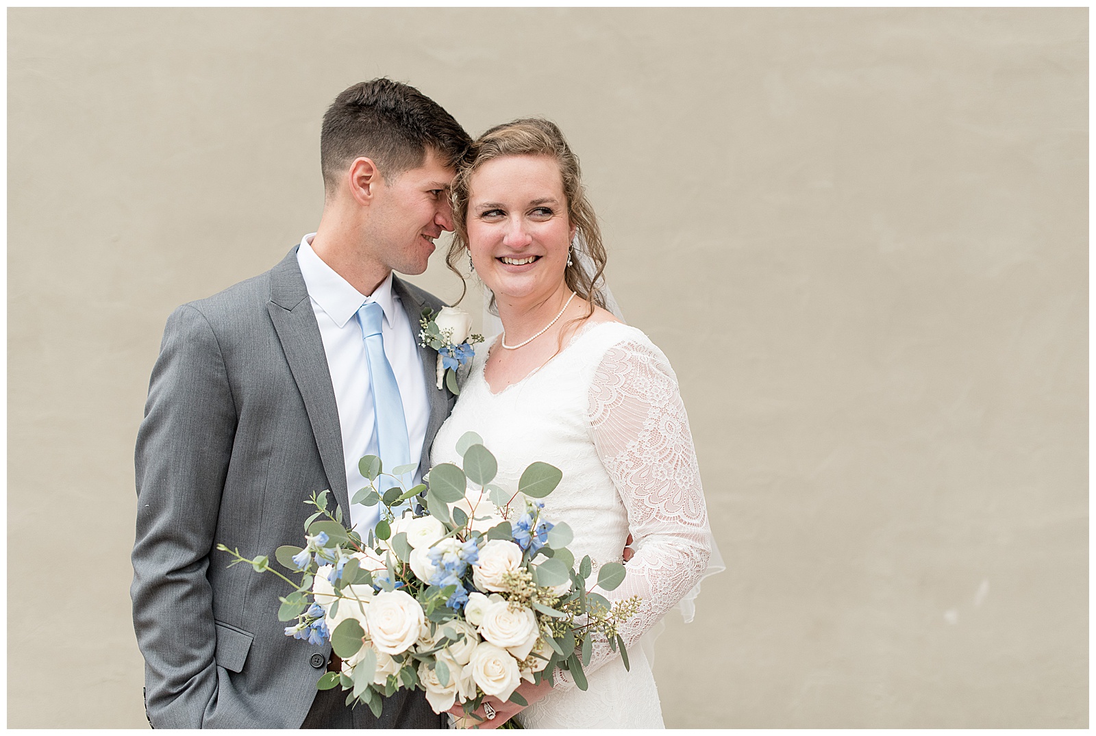 groom rests his forehead against bride as she smiles and holds bouquet in lancaster pennsylvania