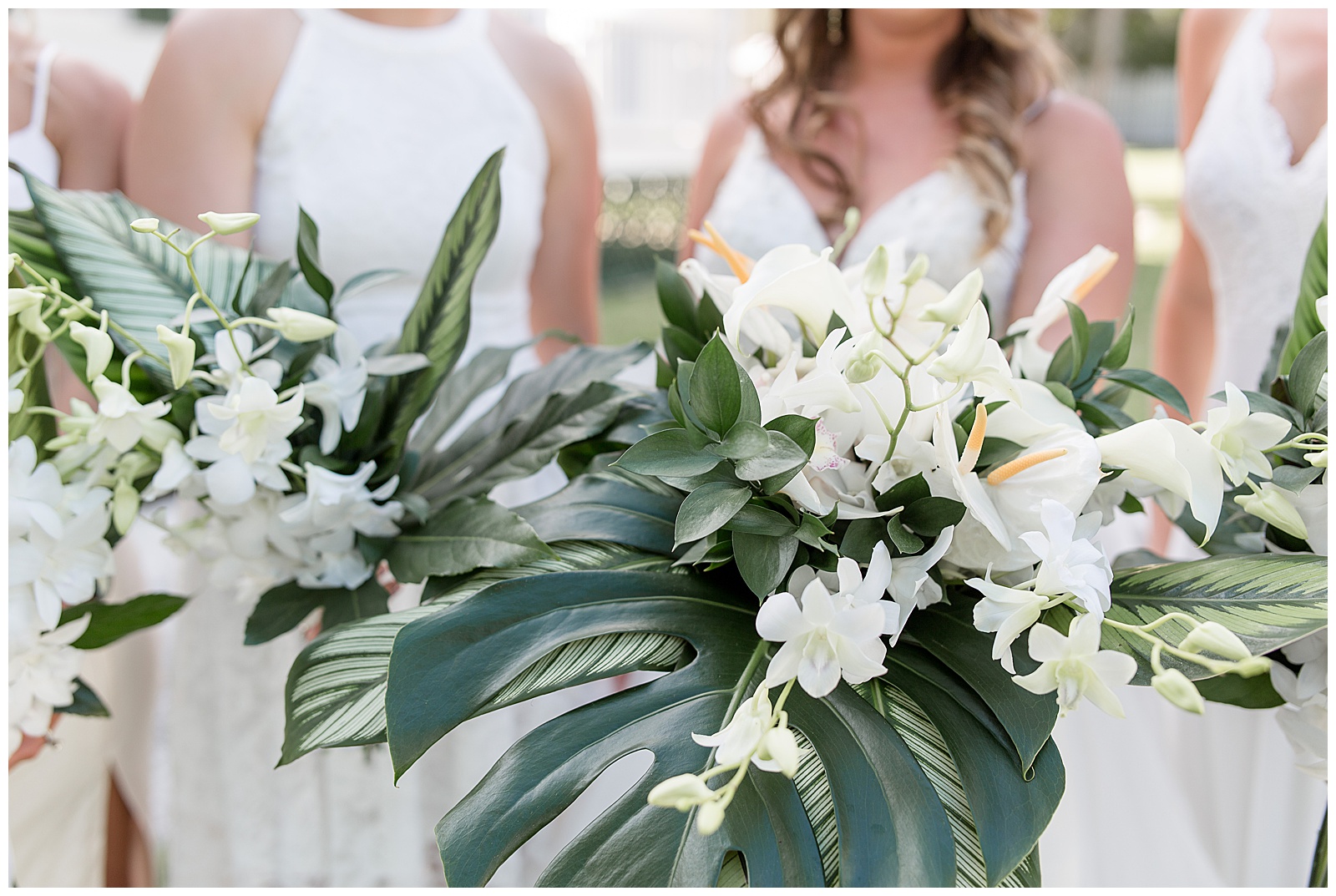 close up of flower bouquets featuring large monstera plant and white lilies and other white flowers in key west florida