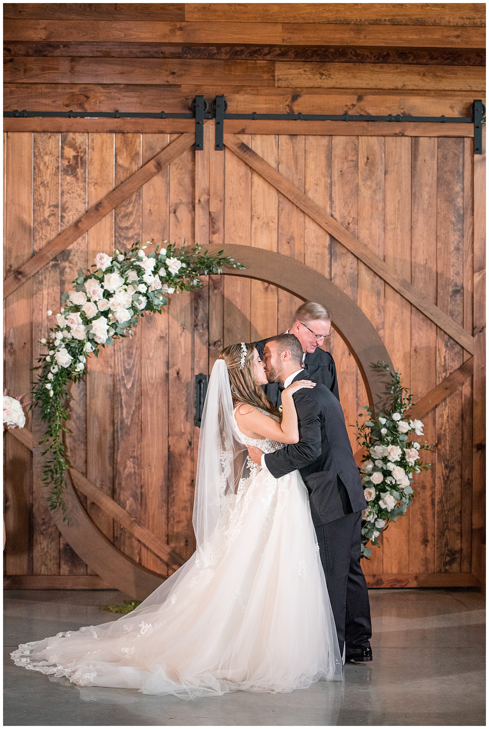 bride and groom kissing during wedding ceremony at the barn at silverstone in lancaster pennsylvania