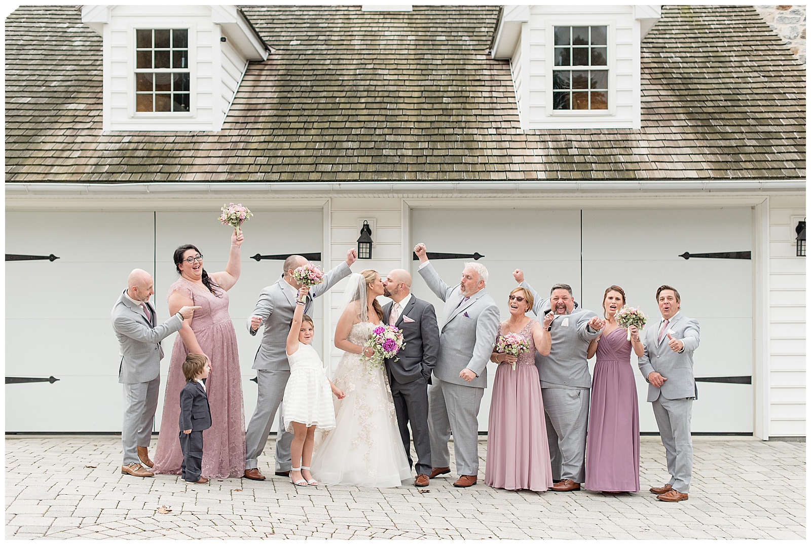 couple surrounded by their cheering bridal party at bluestone estate