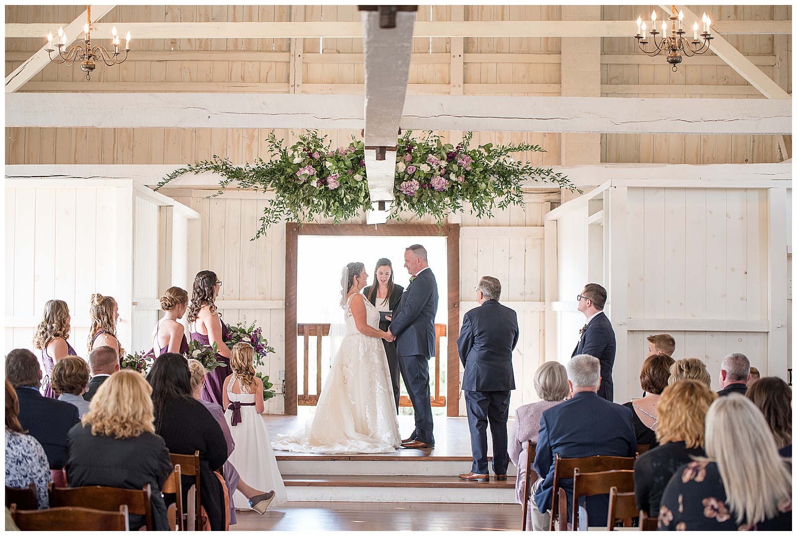 beautiful white barn with stunning floral display hanging from ceiling during wedding at Stoltzfus Homestead and Gardens