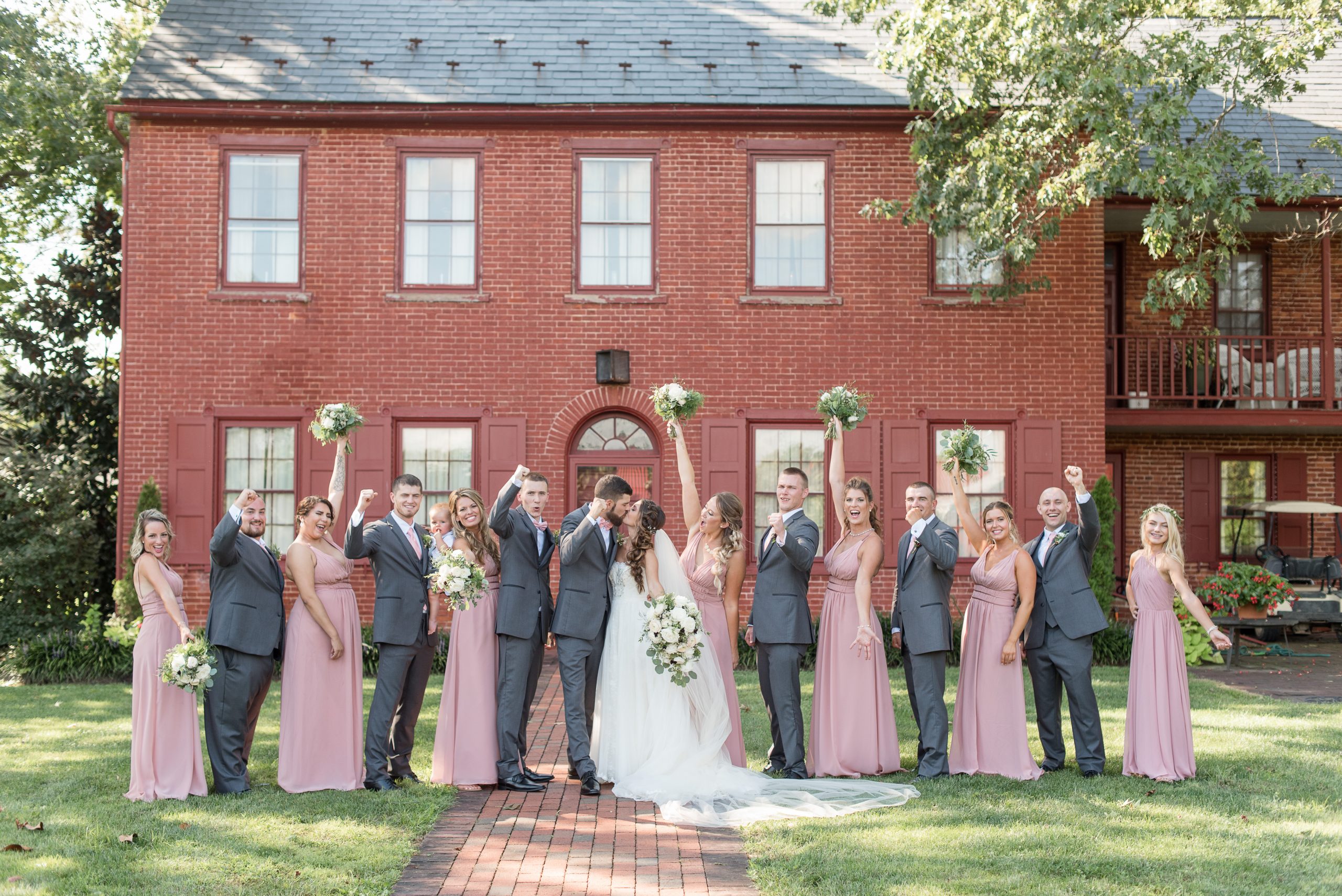 Bridal Party Cheering as husband and wife kiss