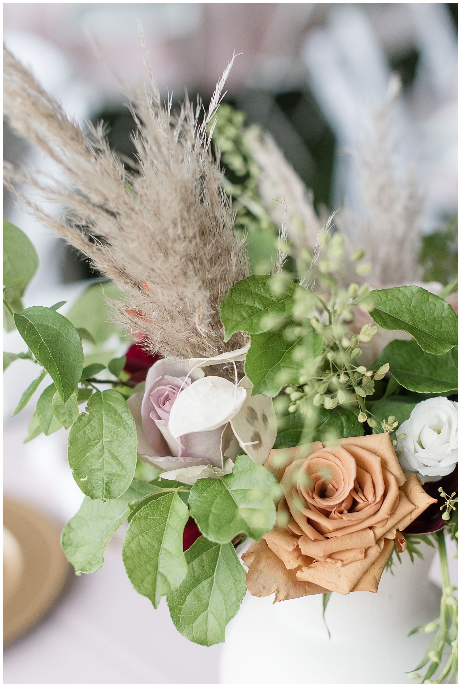 flowers bouquet centerpieces filled with rust colored roses and lilac colored roses and pampas grasses in lancaster pennsylvania