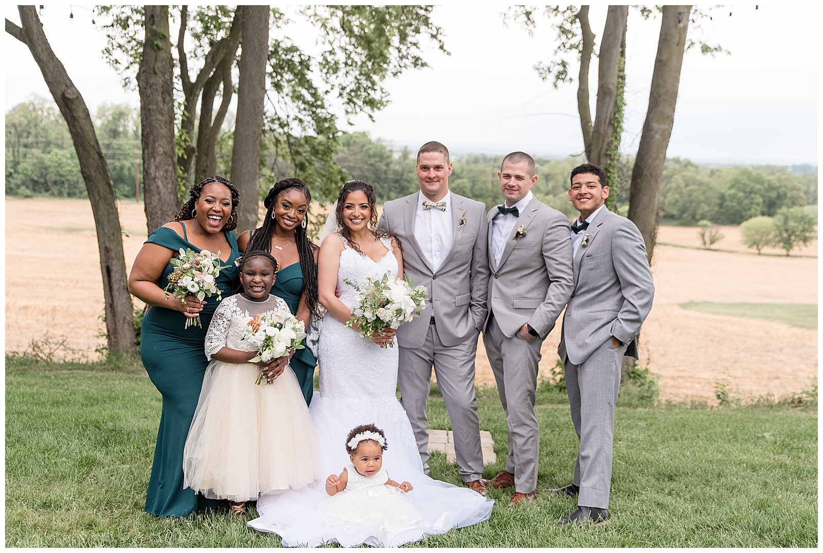 couple surrounded by their two bridesmaids, two groomsmen, junior bridesmaid, and baby flower girl in lancaster pennsylvania