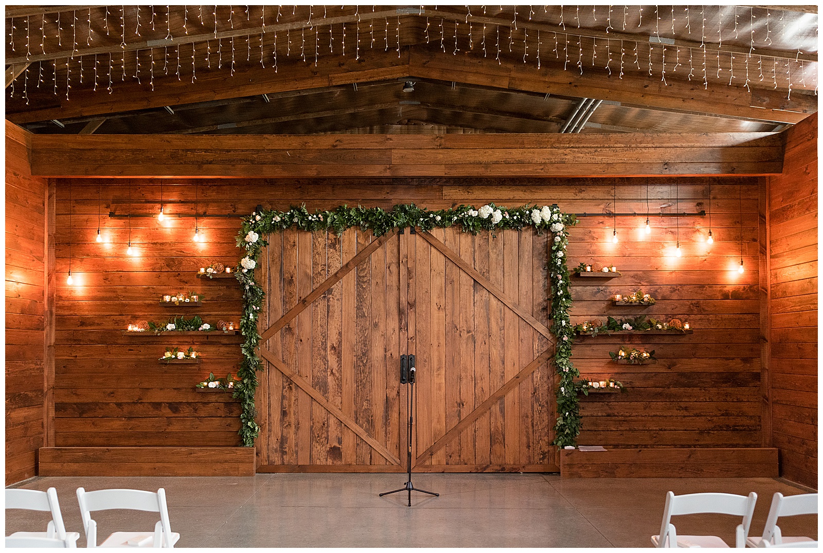 stunning barn wedding venue interior with sliding wooden barn doors at the barn at silverstone