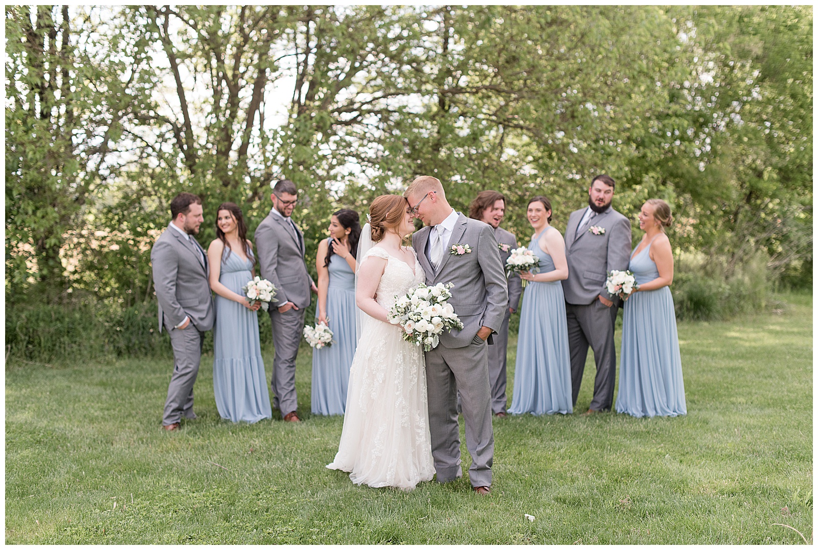 bride and groom resting foreheads together as their bridal party stands in row behind them in lancaster pennsylvania