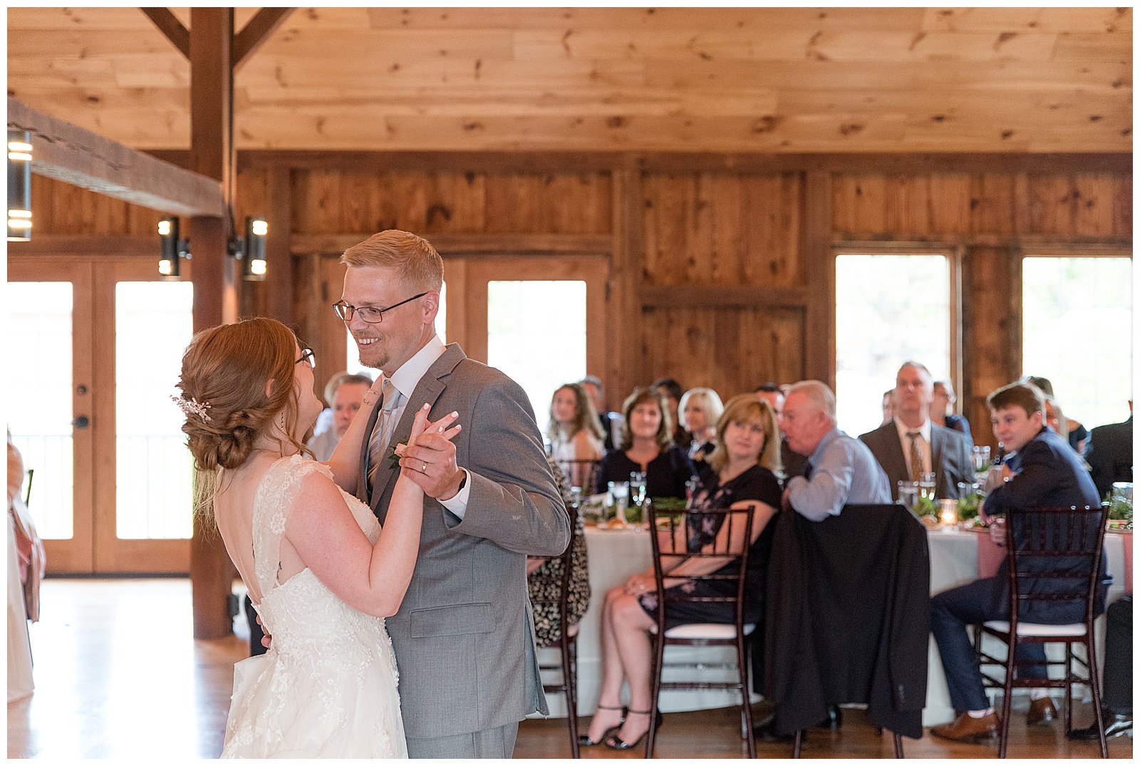bride dances with her father during barn reception and guests watch with joy in lancaster pennsylvania