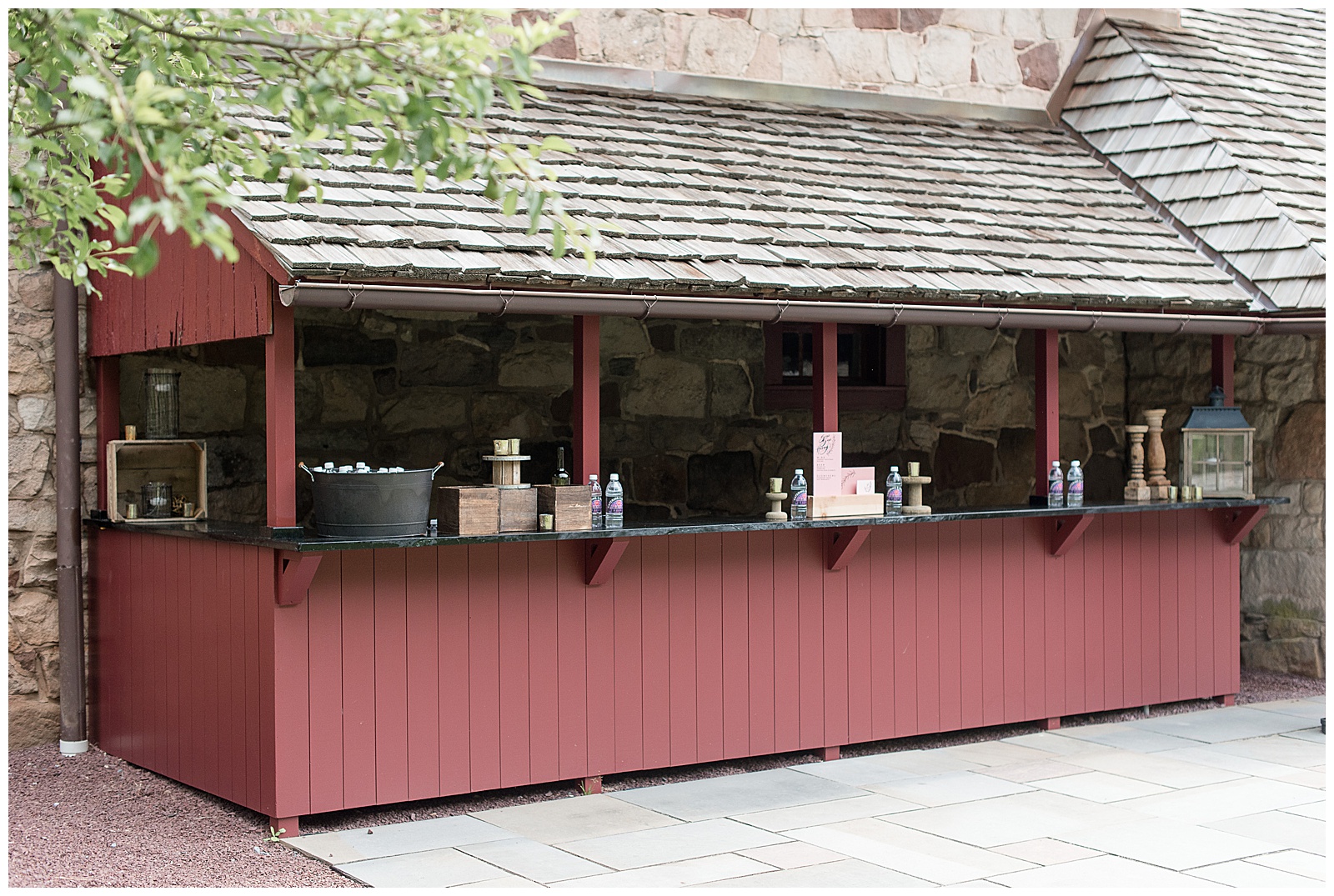 rustic maroon shed with cedar shingles converted into walk-up bar for guests to use at weddings at elizabeth furnace in lititz pennsylvania