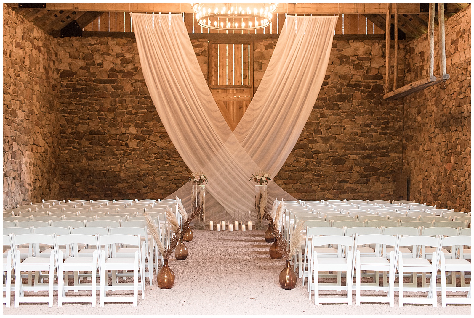 inside elizabeth furnace stone wedding venue with beautiful modern decor and rows of white chairs in lititz pennsylvania