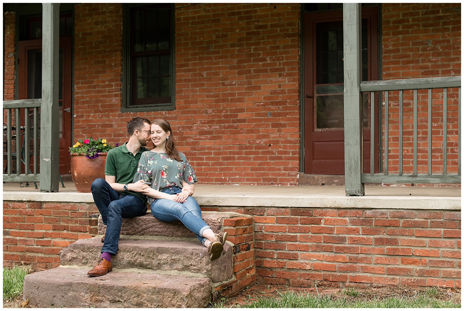 couple sitting close on beautiful red brick farmhouse front porch at private residence in central pennsylvania
