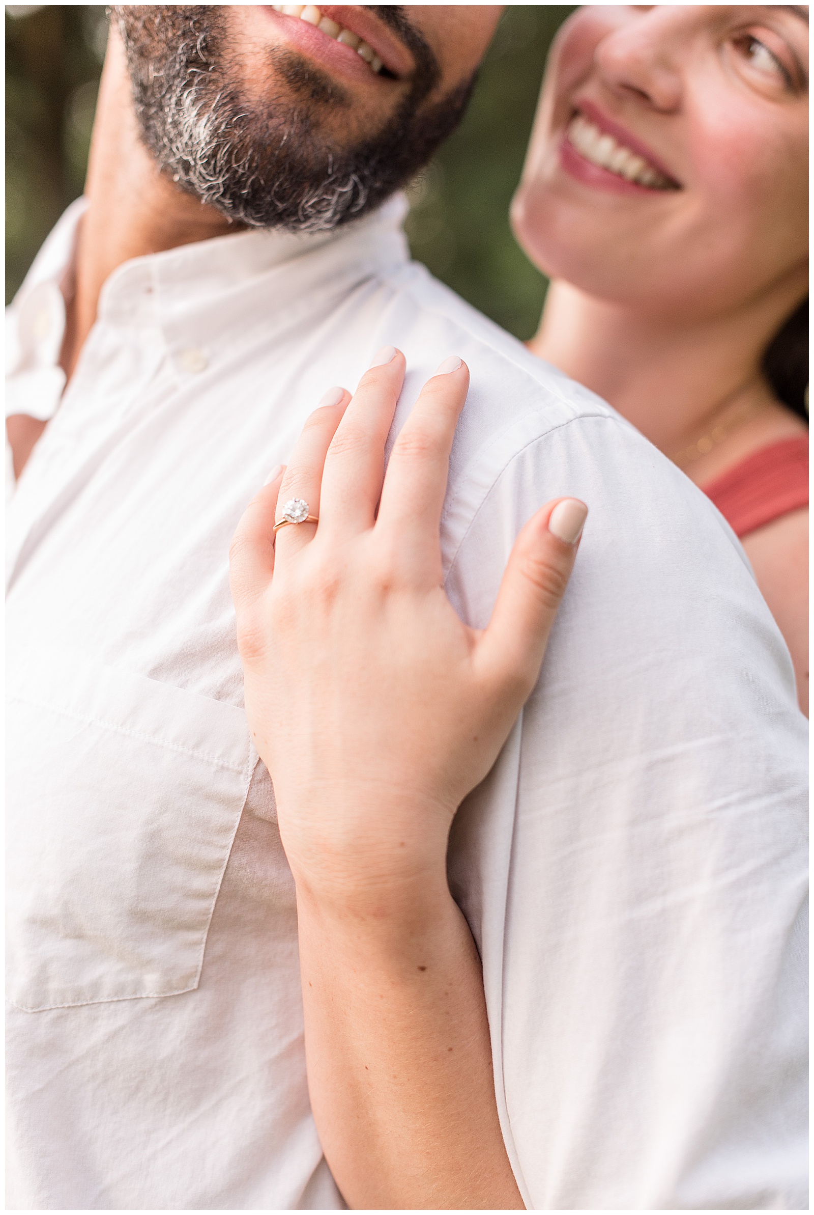 close up photo of woman displaying engagement ring with her hand wrapped around him in pennsylvania