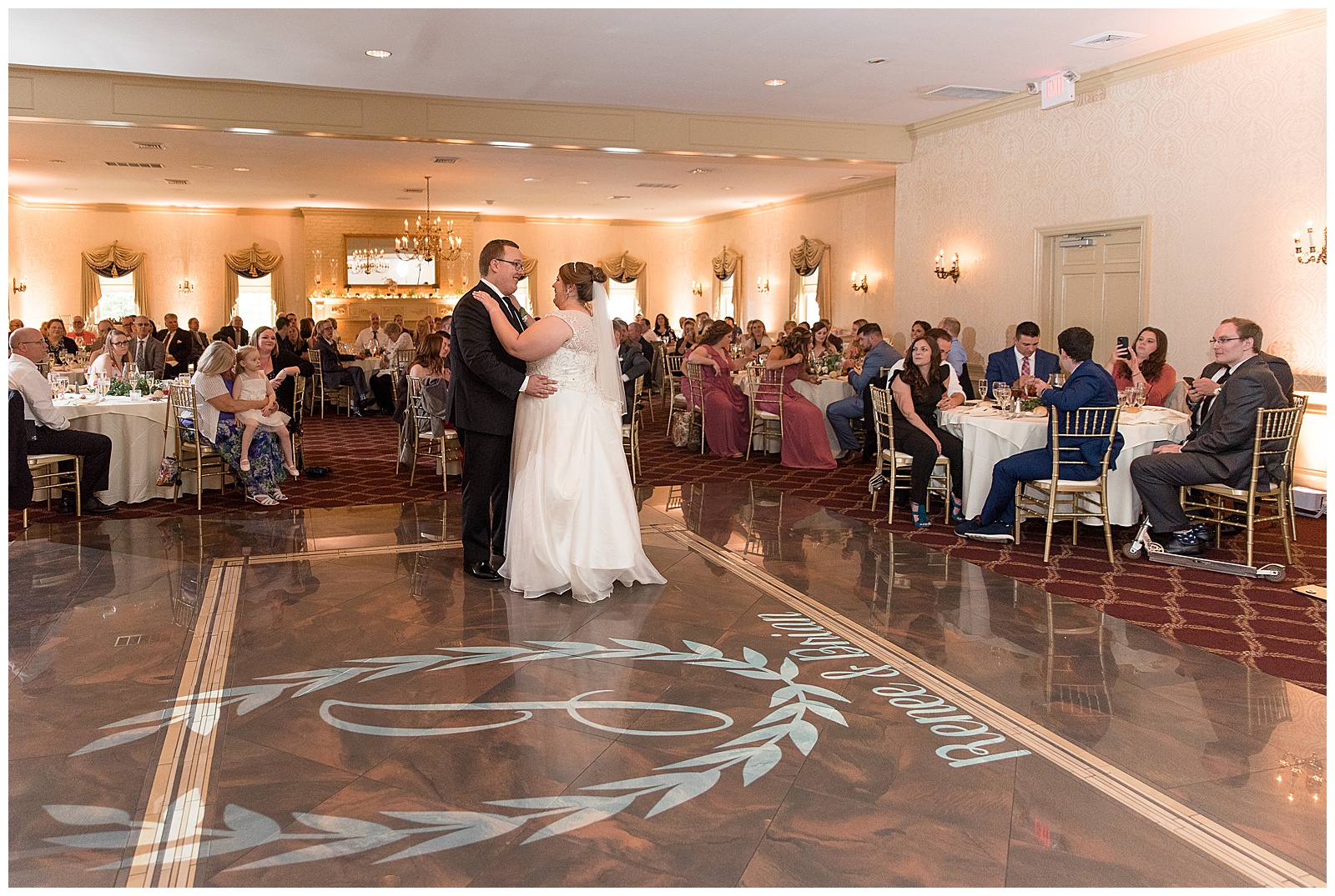 bride and groom taking their first dance as a married couple during their reception in the ballroom of willows at historic strasburg