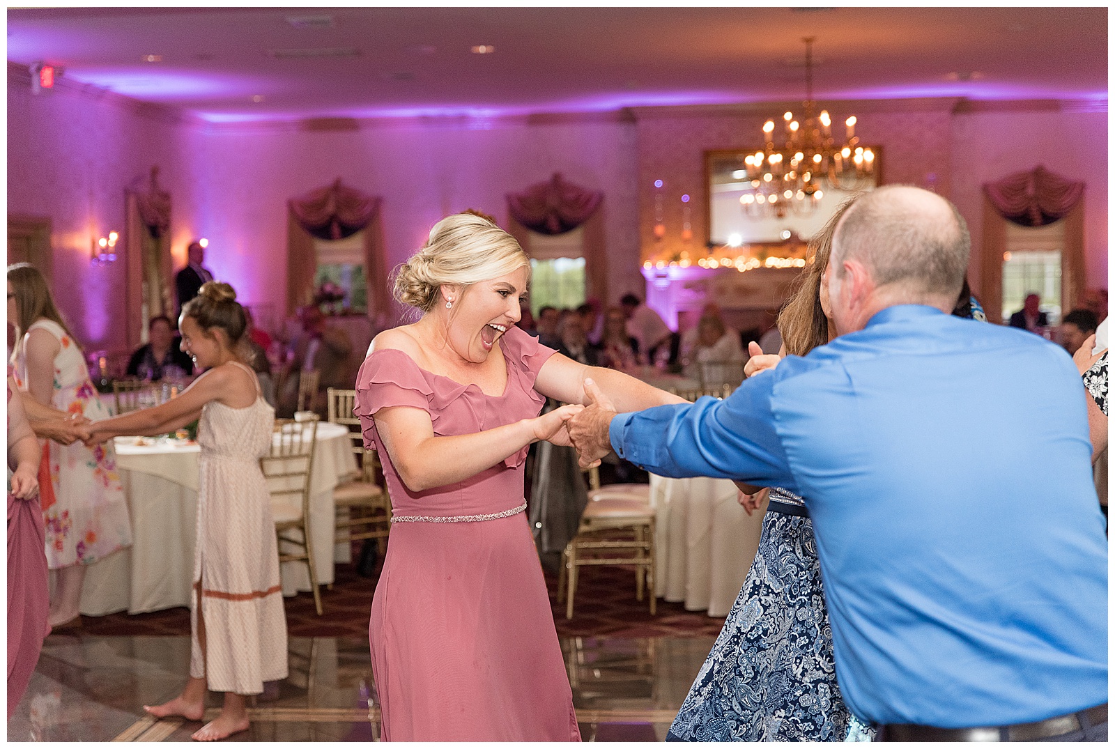 wedding guests laughing and dancing during fun reception inside willows at historic strasburg
